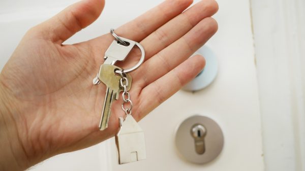 Hand holding keys representing closing on a real estate transaction