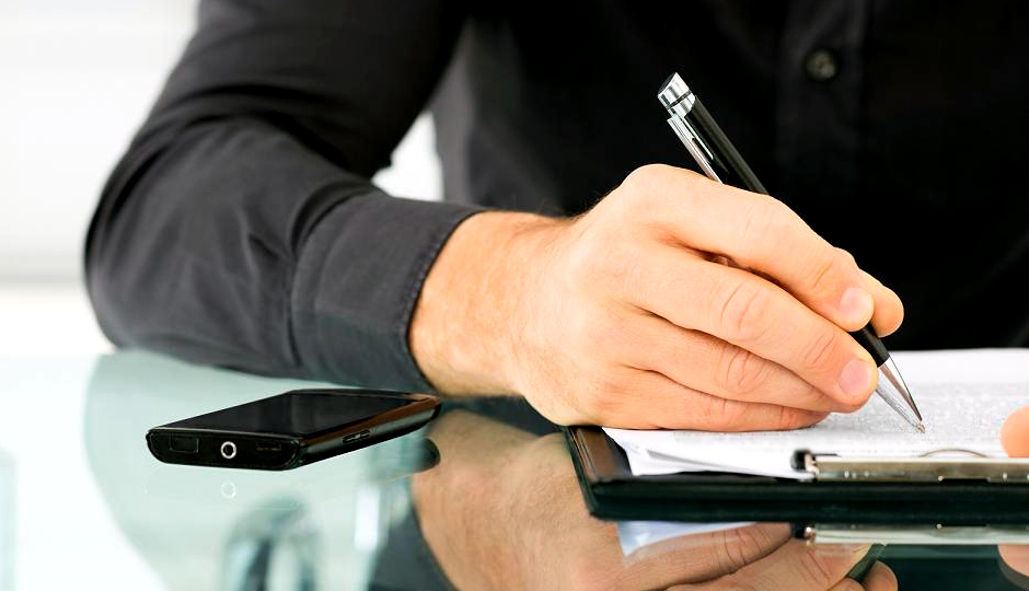 Man writing representing studying and learning.
