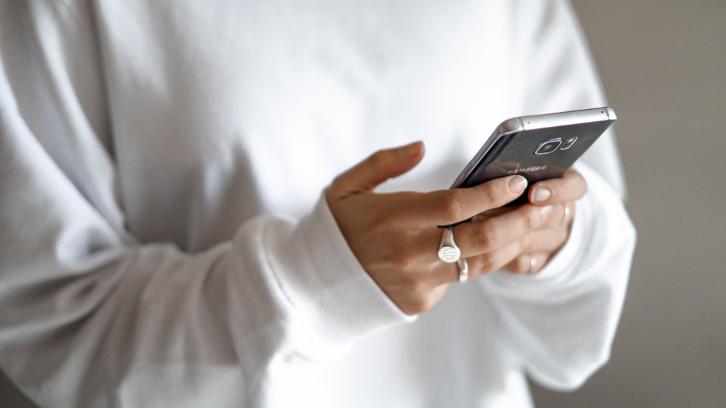 Person holding phone representing AI content