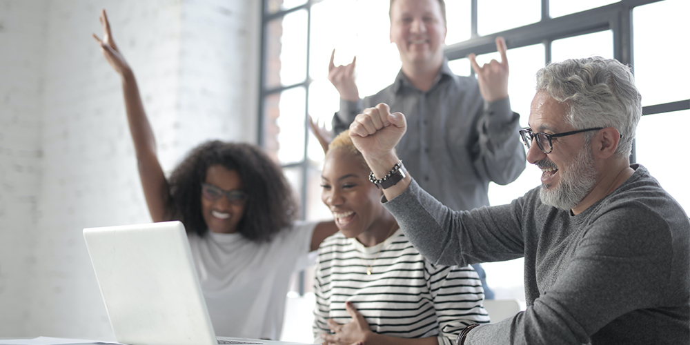 Team building with virtual icebreakers around a computer.