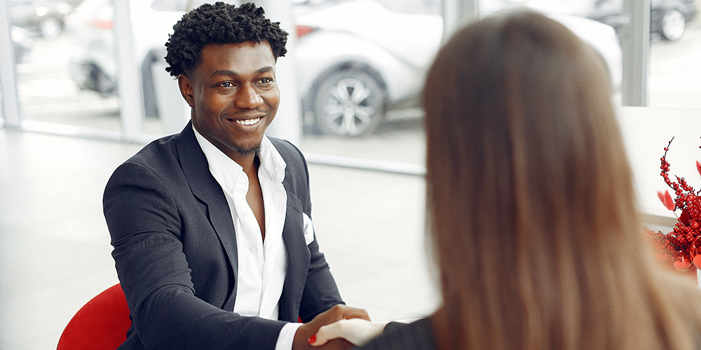 Agents sitting at a closing table negotiating a deal