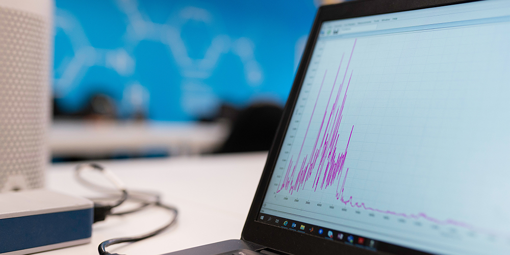 Web analytics open on a desktop screen on a table.