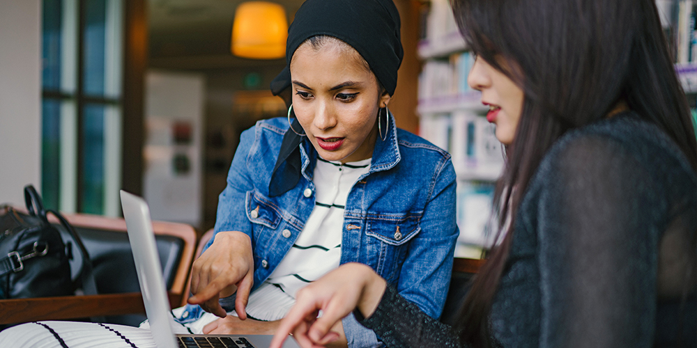 Women over laptop to support small business.