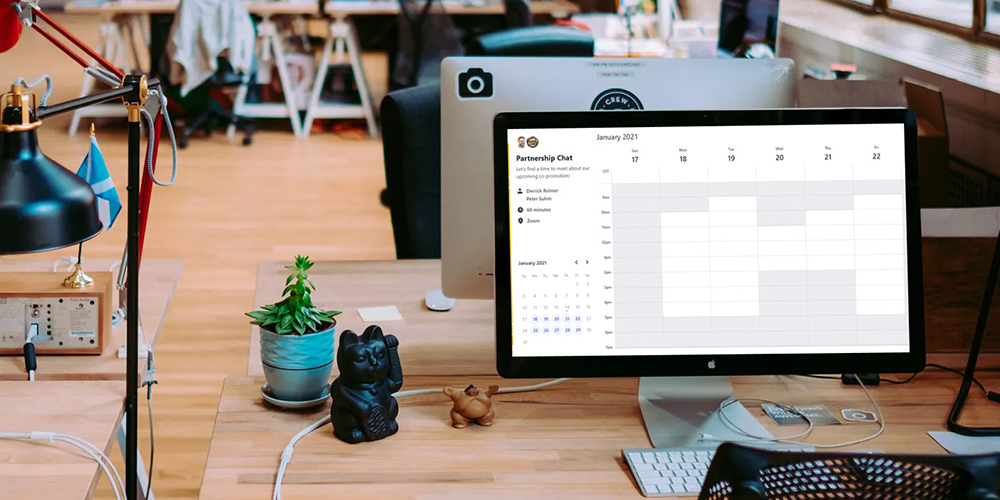 Computer on a desk in open office with SavvyCal, a scheduling tool, open on the computer.