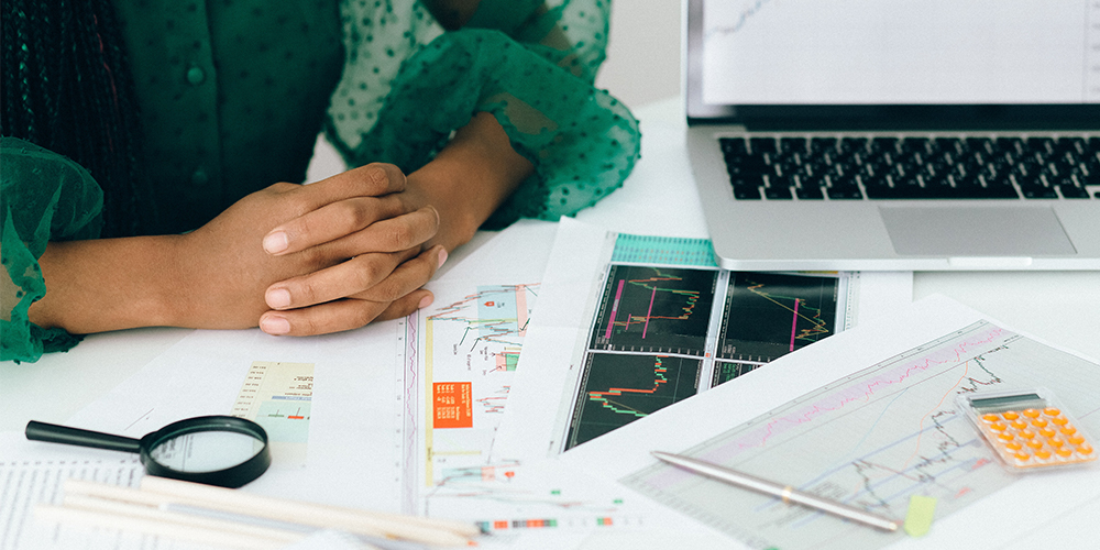 Woman with paperwork representing clients negotiating.