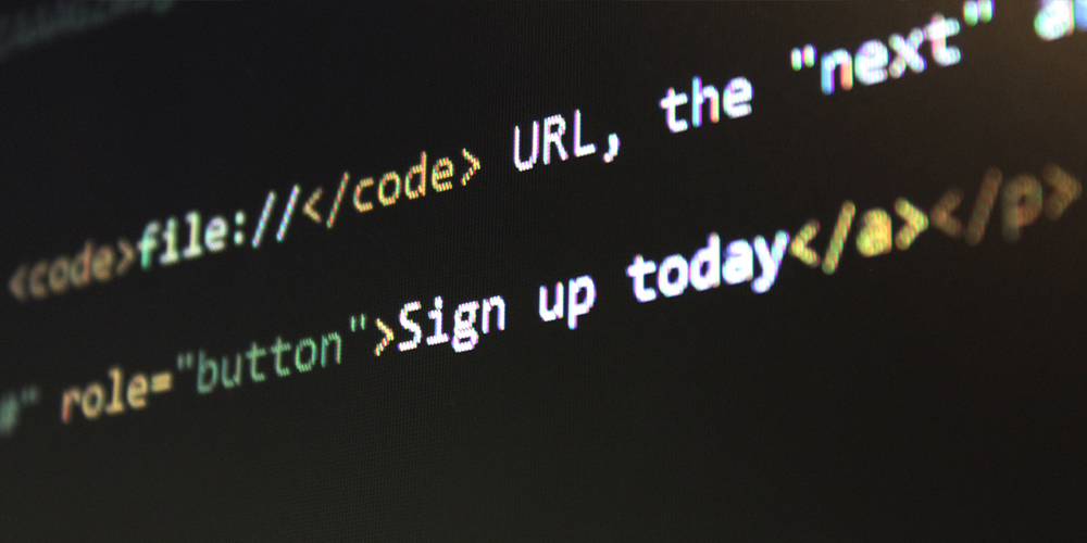 Picture of a screen with HTML code written on it, showing the title tag and a sign up button.