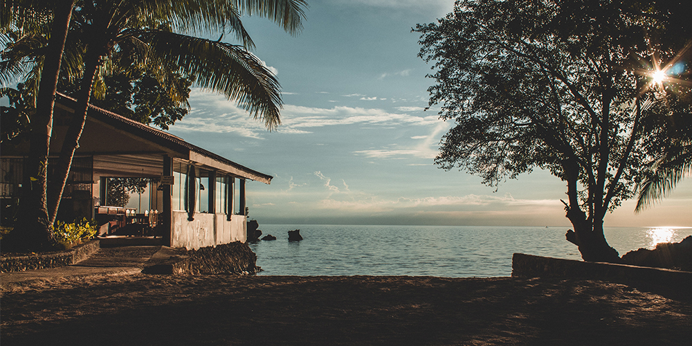 A second home on a lakefront property at sunset.