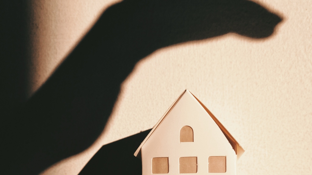 shadowing hand over house