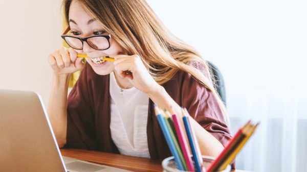 Person feeling self-doubt looking at their computer