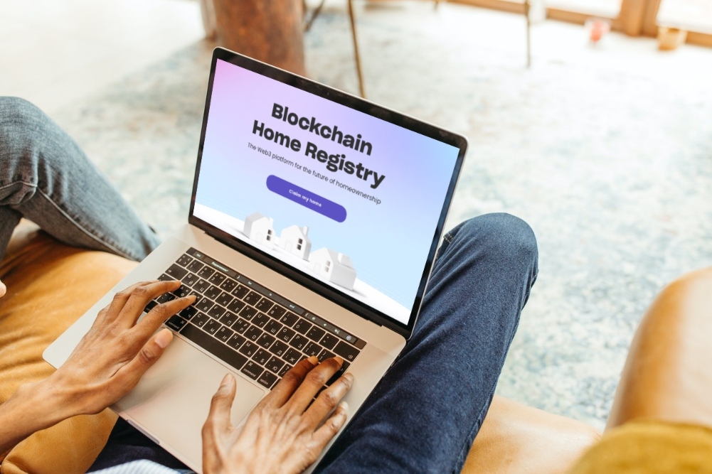 Man using laptop to look at Blockchain Home Registry