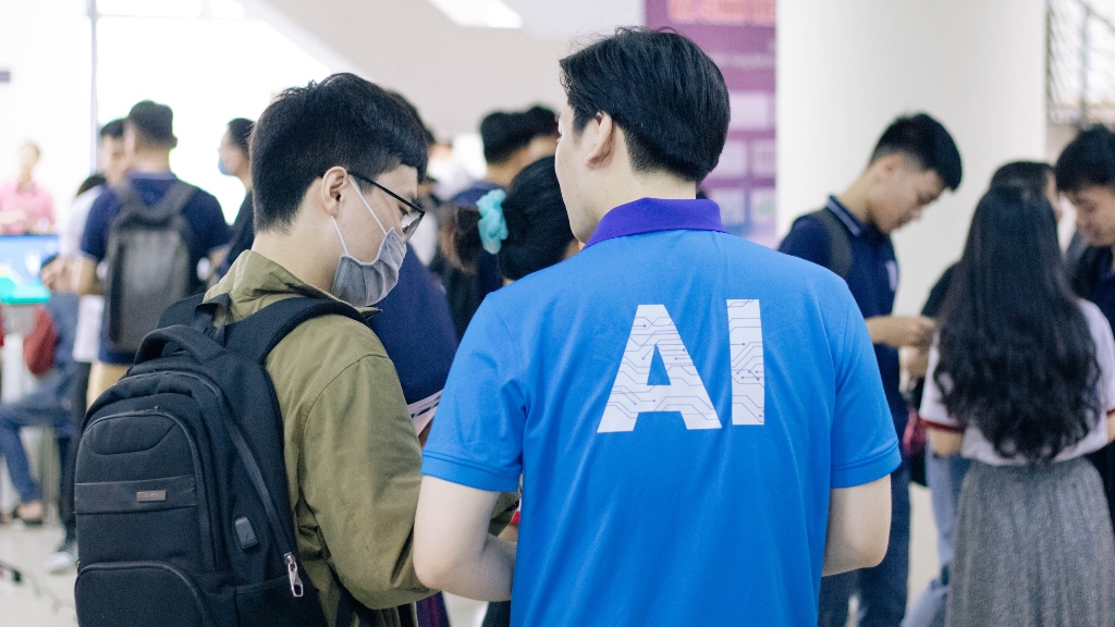 person wearing blue ai shirt