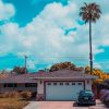 Home in California with palm tree representing using it as a side hustle in TV