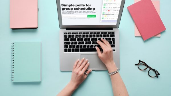 TallyCal on laptop with notebooks all over desk and glasses.