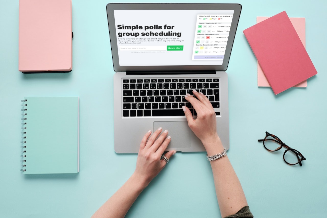 TallyCal on laptop with notebooks all over desk and glasses.