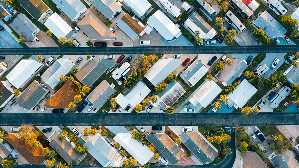 An aerial view of a neighborhood in diagonal lines from each other, showing part of the housing market.