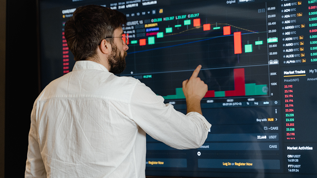 A man standing in front of different housing market charts analyzing data for insight on a black swan event.