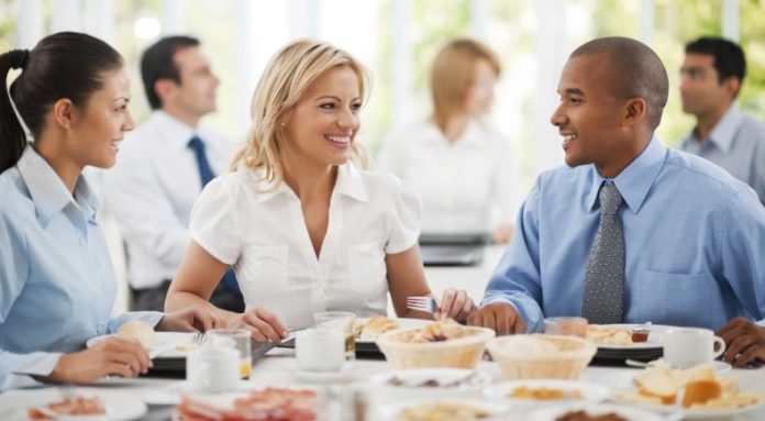 Businesspeople having lunch indoors. negotiation diversity activism