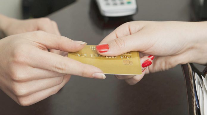 Handing over card representing getting paid.