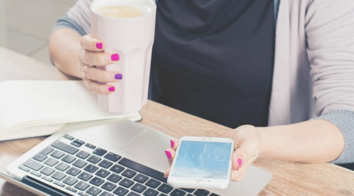 Entrepreneur using phone and computer representing women's career hacks.