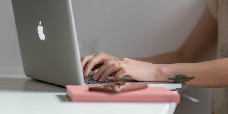 person on laptop typing an email
