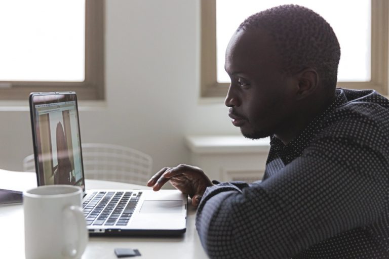 video job interview with man in front of computer.