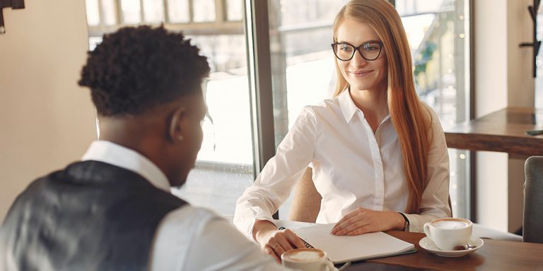 Man and women in interview using tips to sound more confident.