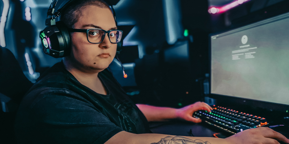 Twitch streamer in front of gaming PC, likely to face DMCA claims.