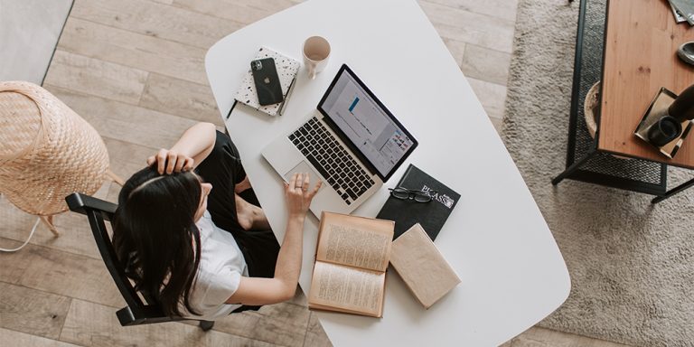 Woman working in office with remote team