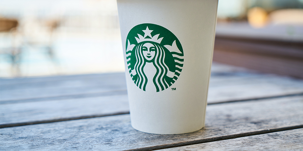 A franchise cup on a wooden table.