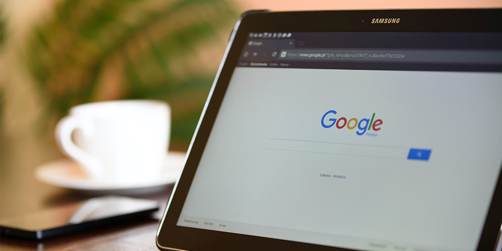 Google open on a tablet, with no third-party cookies, with a coffee cup in the background behind the tablet in the foreground.