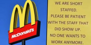 McDonald's sign with a sign that says "We are short staffed. Please be patient with the staff that did show up. No one wants to work anymore."