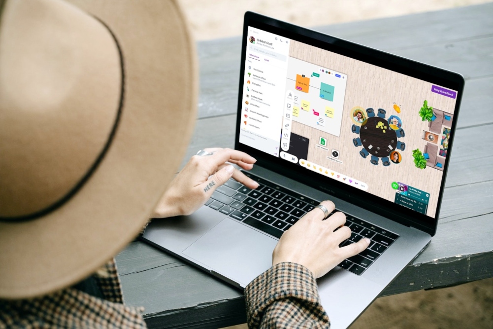 orbital Woman using orbital remote work tool on computer.