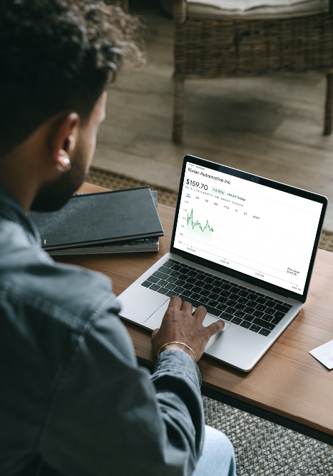 Rivian Stock on Laptop Man looking at Rivian stock price on laptop