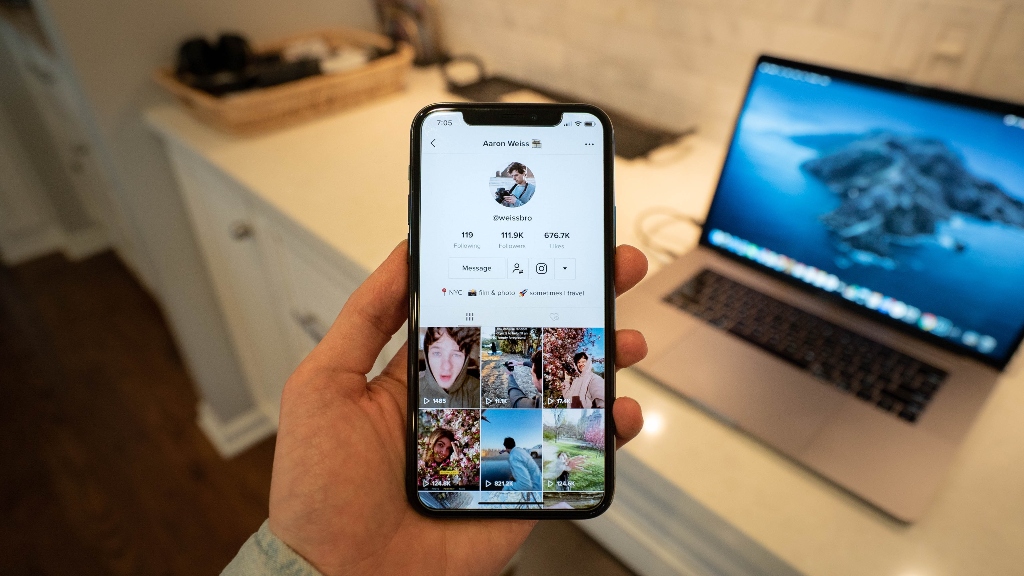 Person on TikTok video Person on tiktok profile on phone representing analytics