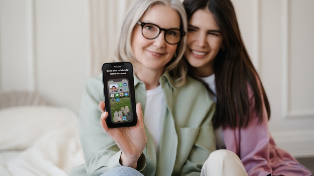 Woman holding phone with Locket on screen Woman holding phone with Locket on screen
