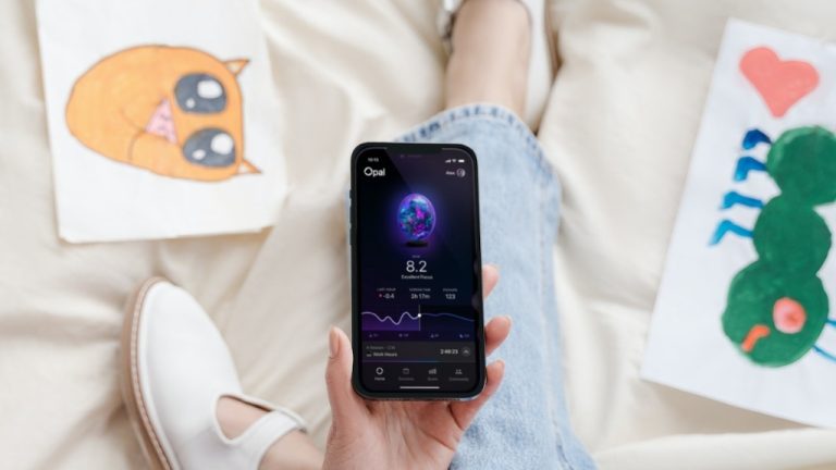 Opal apps on iphone being held by artist