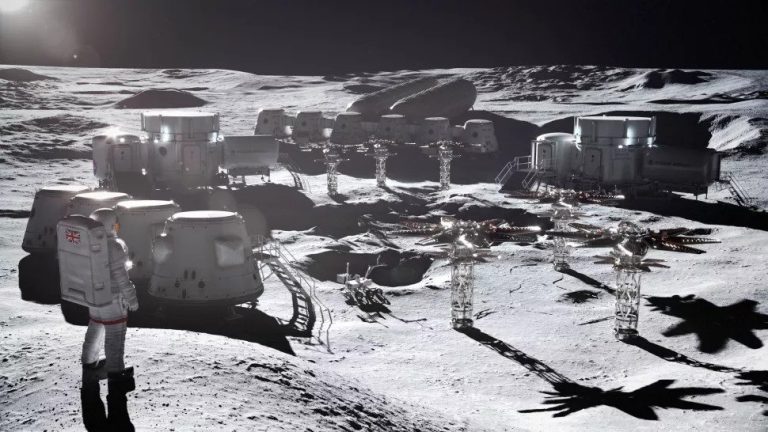 An astronaut stands on the moon besides white lunar base buildings built by Rolls-Royce